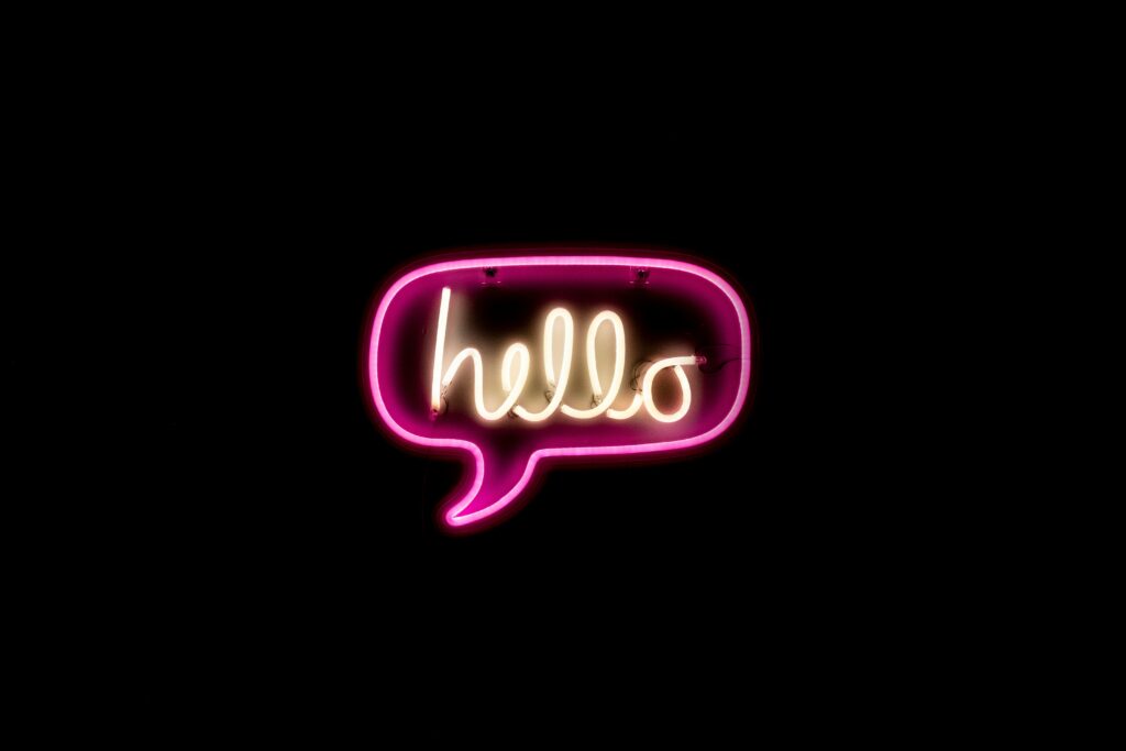 A black box with a neon saying hello. This is to say hi to our new website visitors to announce our new website and new social media manager, Sam. 